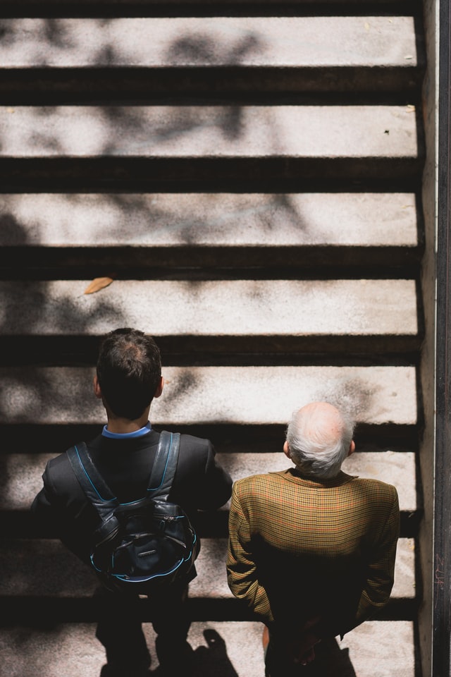man and old man walking up stairs